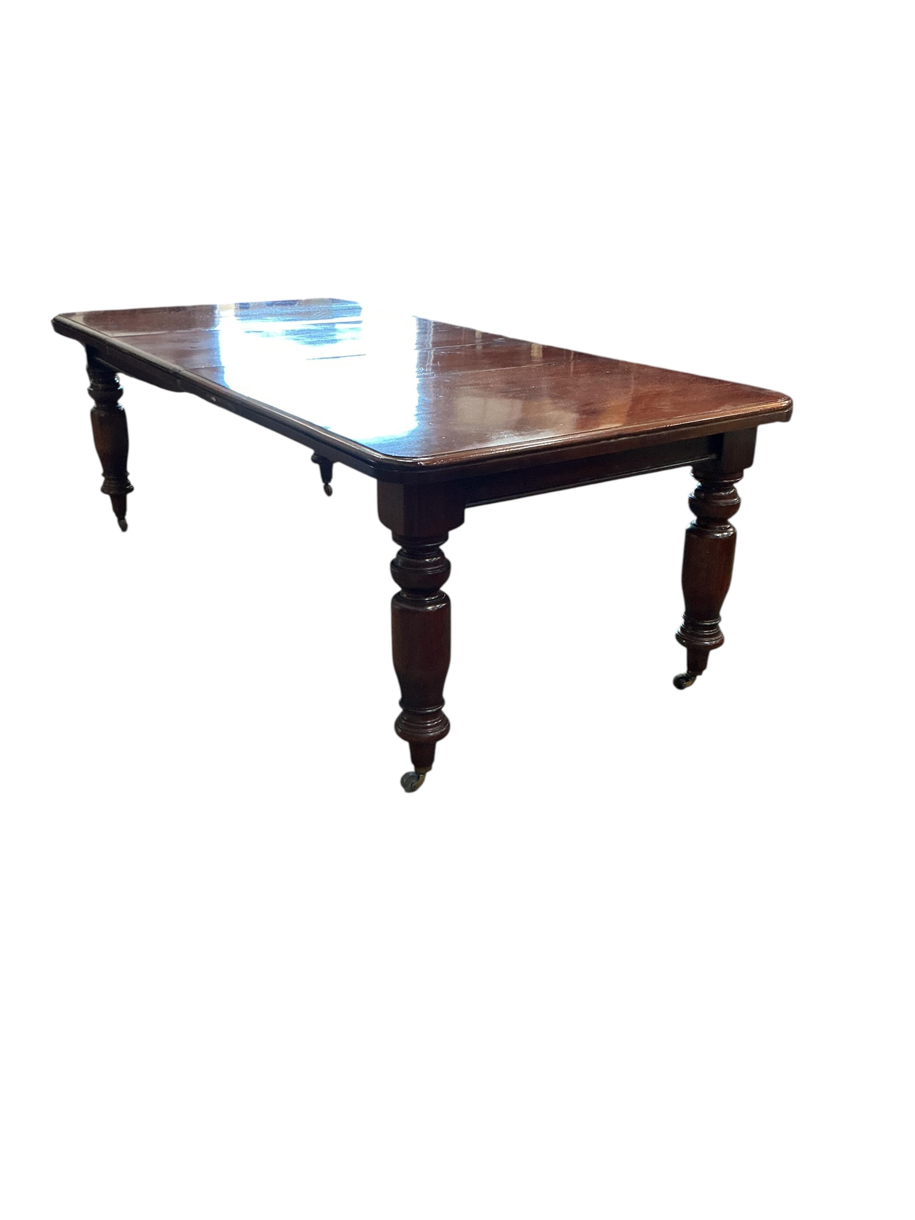 A Victorian style mahogany extending dining table, width 226cm extended, two spare leaves together with a set of eight Chippendale Revival mahogany dining chairs, two with arms